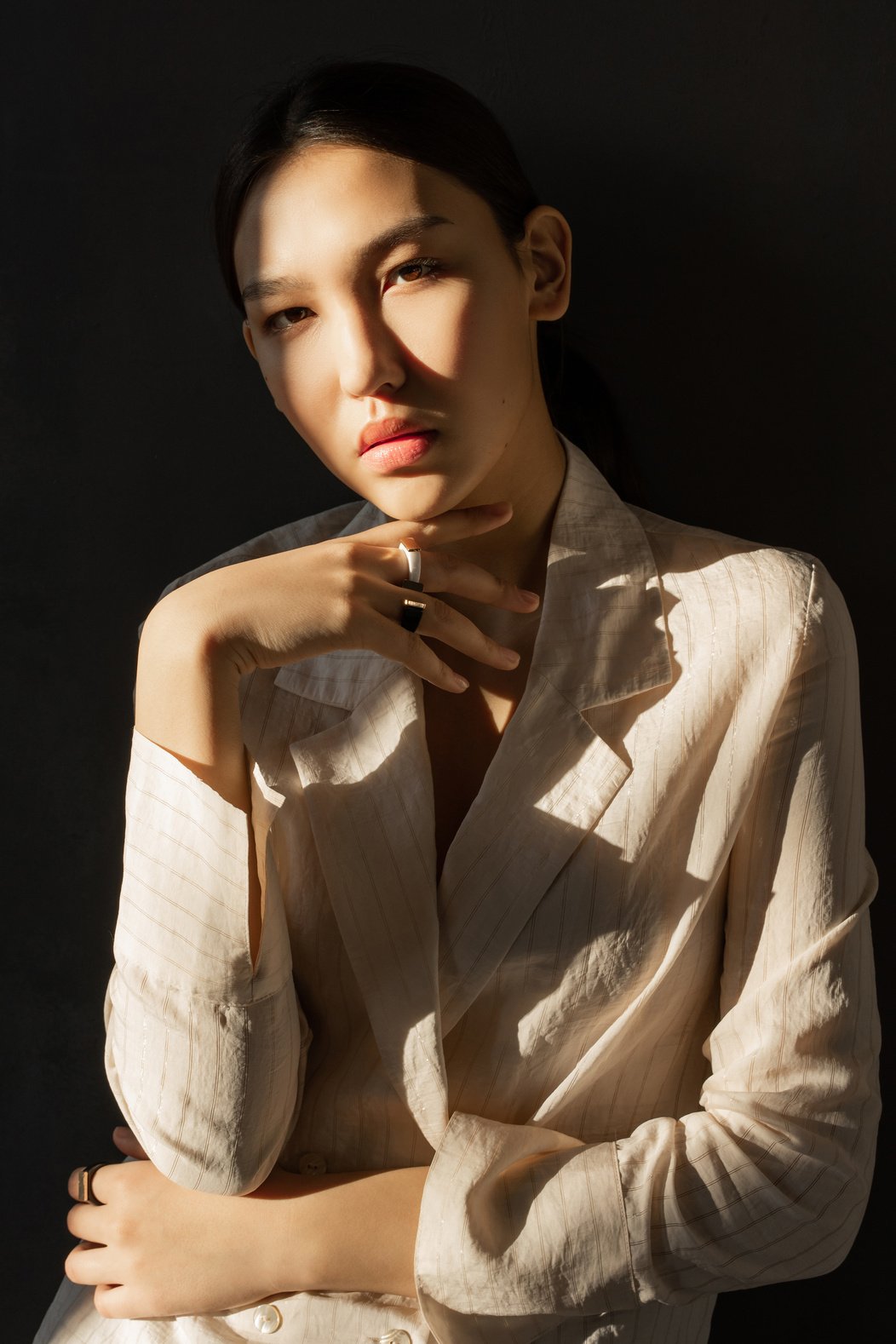 Woman in Brown Blazer With Black Background